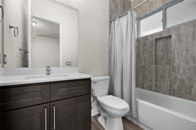 full bath featuring wood finished floors, toilet, vanity, and shower / bath combo