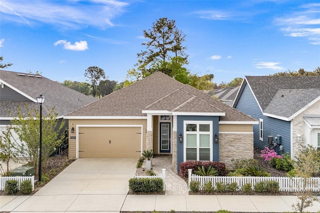 view of front of property with a garage, fence, concrete driveway, and roof with shingles