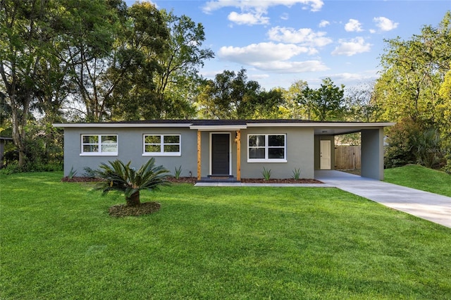 single story home with driveway, an attached carport, a front yard, and stucco siding