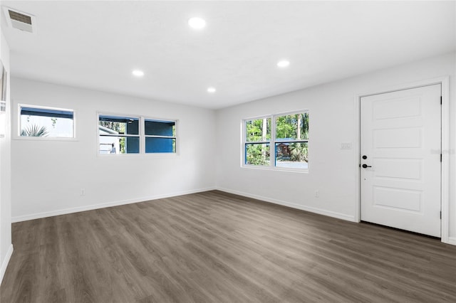interior space featuring recessed lighting, dark wood-style floors, baseboards, and visible vents