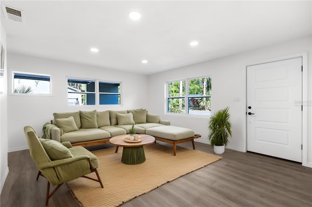 living room with baseboards, visible vents, wood finished floors, and recessed lighting