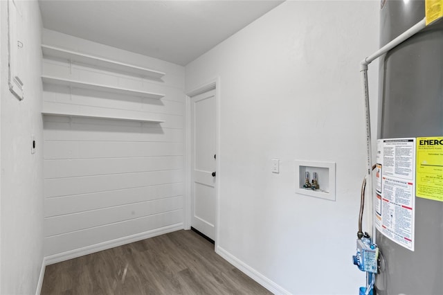 clothes washing area with water heater, hookup for a washing machine, baseboards, laundry area, and wood finished floors