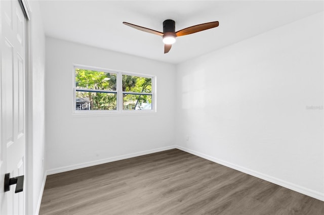 unfurnished room with baseboards, wood finished floors, and ceiling fan