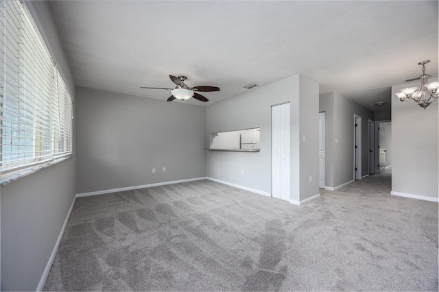 501 SW 75th St Unit E3, Gainesville, FL 32607 - carpeted spare room featuring ceiling fan, baseboards, and a chandelier