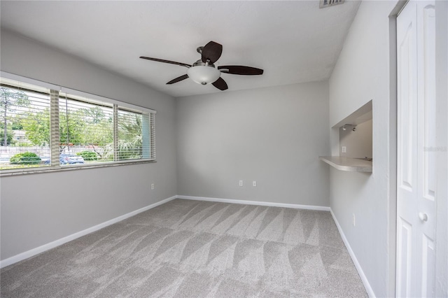 501 SW 75th St Unit E3, Gainesville, FL 32607 - unfurnished room with carpet floors, a ceiling fan, and baseboards