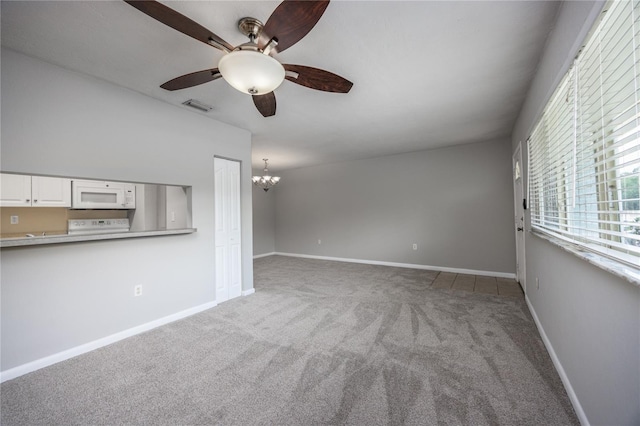 501 SW 75th St Unit E3, Gainesville, FL 32607 - unfurnished living room with carpet flooring, ceiling fan, a chandelier, and baseboards
