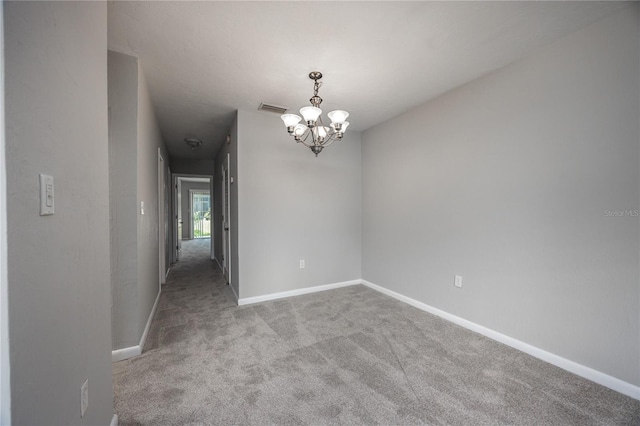 501 SW 75th St Unit E3, Gainesville, FL 32607 - spare room featuring a chandelier, carpet flooring, and baseboards
