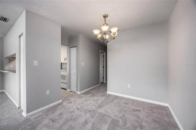 501 SW 75th St Unit E3, Gainesville, FL 32607 - unfurnished room with light colored carpet, a chandelier, and baseboards