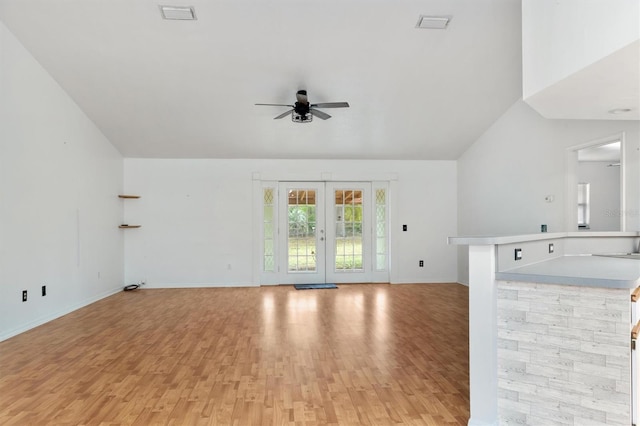 unfurnished living room featuring baseboards, visible vents, ceiling fan, and light wood-type flooring