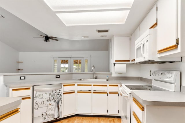 kitchen featuring light countertops, white appliances, a sink, visible vents, and a ceiling fan