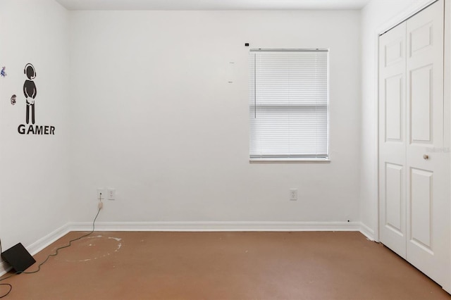 unfurnished room featuring baseboards