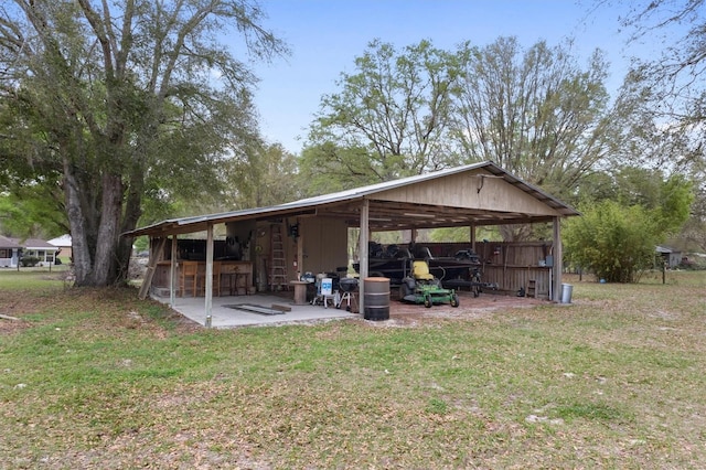 view of pole building with a lawn and a carport