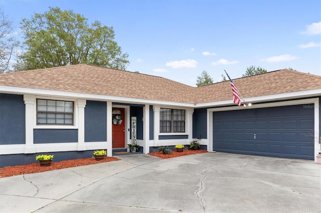 single story home with roof with shingles, stucco siding, and concrete driveway