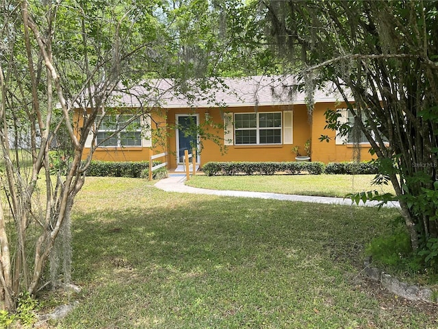 ranch-style home with a front yard