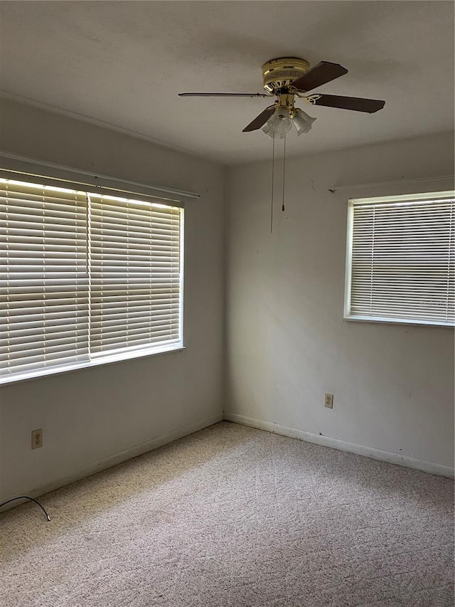 unfurnished room with baseboards, ceiling fan, and carpet floors