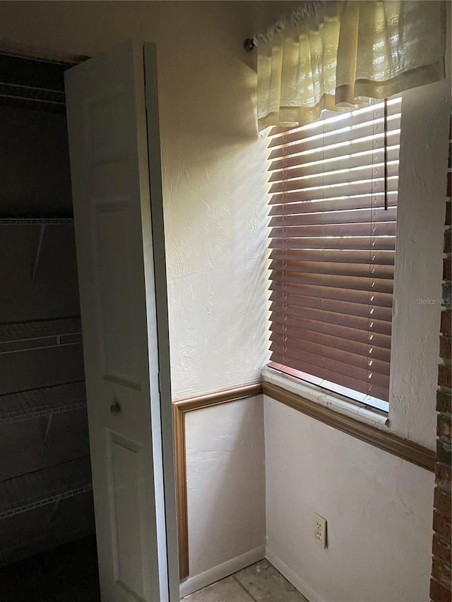 interior space featuring baseboards