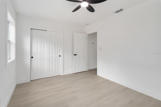 4120 NW 10th St, Gainesville, FL 32609 - unfurnished bedroom with light wood finished floors, baseboards, a closet, and a ceiling fan