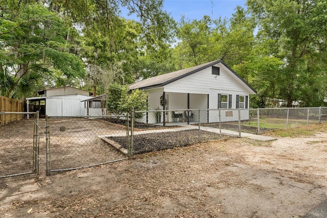 4120 NW 10th St, Gainesville, FL 32609 - back of house with a gate and view of wooded area