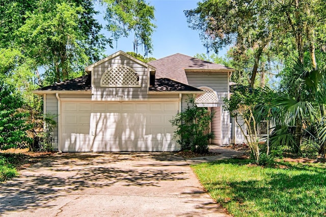12332 NW 7th Ln, Newberry, FL 32669 - view of front of house with concrete driveway, a shingled roof, and a garage