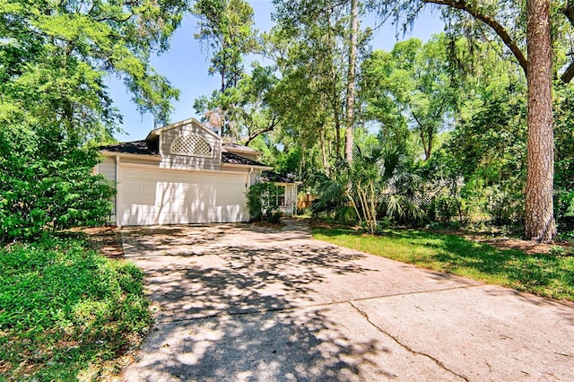 12332 NW 7th Ln, Newberry, FL 32669 - view of patio / terrace featuring a garage and concrete driveway