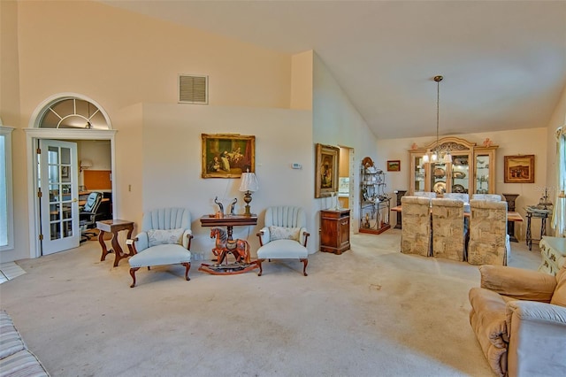 12332 NW 7th Ln, Newberry, FL 32669 - living area with carpet, visible vents, a healthy amount of sunlight, a chandelier, and high vaulted ceiling