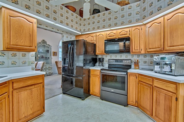 12332 NW 7th Ln, Newberry, FL 32669 - kitchen with light countertops, wallpapered walls, tasteful backsplash, and black appliances