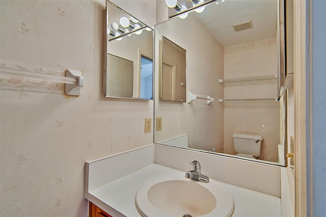 12332 NW 7th Ln, Newberry, FL 32669 - bathroom featuring toilet, vanity, and visible vents