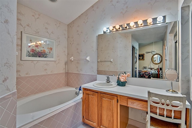 12332 NW 7th Ln, Newberry, FL 32669 - bathroom featuring a garden tub, vanity, and wallpapered walls