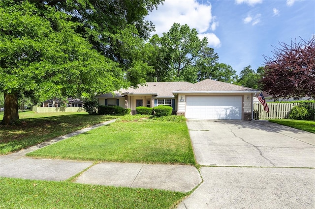 ranch-style home with fence, an attached garage, concrete driveway, and a front lawn