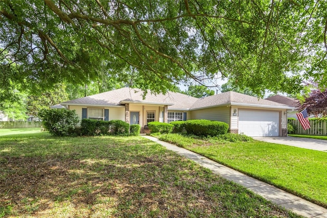ranch-style house with fence, brick siding, a garage, a front yard, and concrete driveway