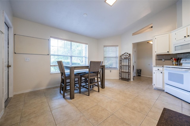 dining space with light tile patterned floors and baseboards