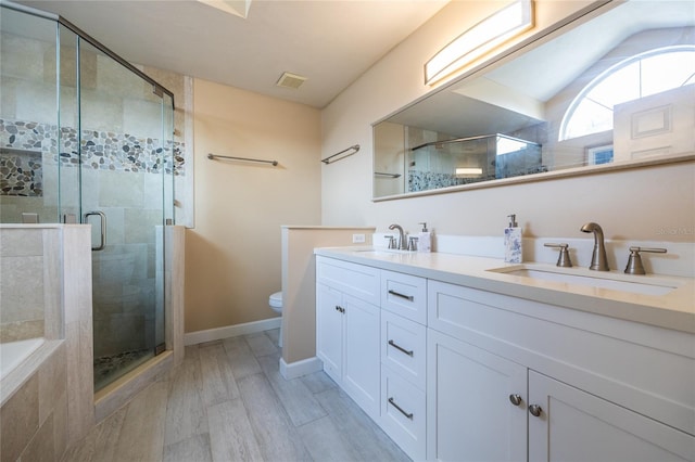 bathroom with double vanity, a sink, and a stall shower