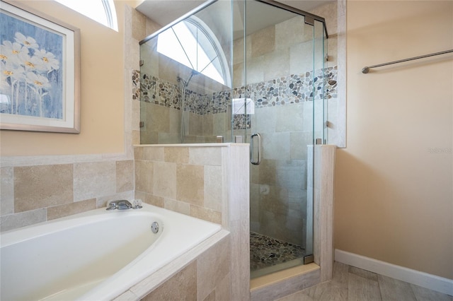 full bath with a garden tub and a stall shower