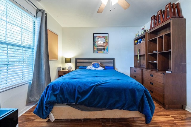 bedroom with baseboards, a ceiling fan, and wood finished floors