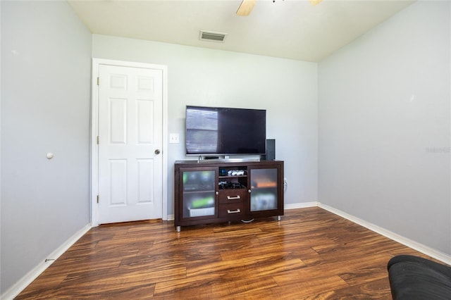 interior space with a ceiling fan, baseboards, visible vents, and wood finished floors