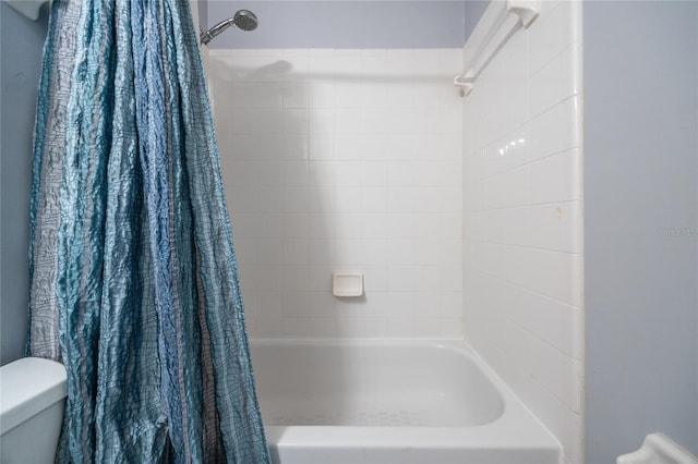 bathroom with toilet and shower / tub combo