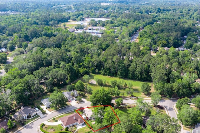 drone / aerial view with a residential view and a view of trees