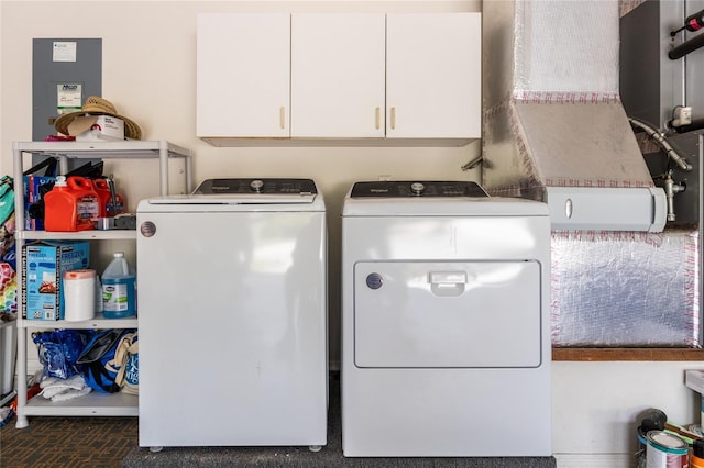 laundry area featuring washer and clothes dryer and brick floor
