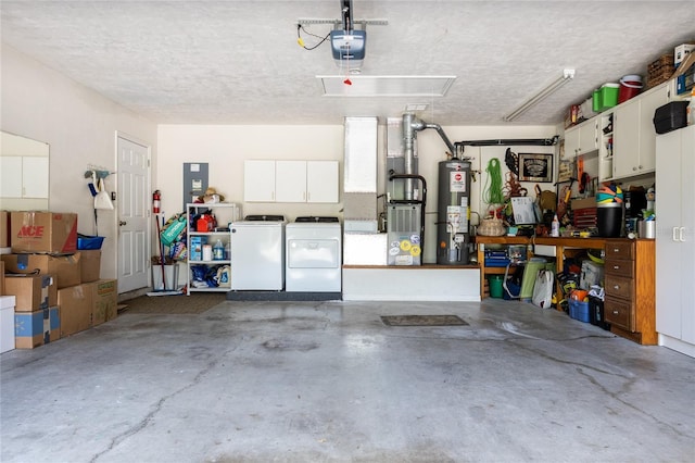 garage featuring washer and clothes dryer, a garage door opener, and water heater
