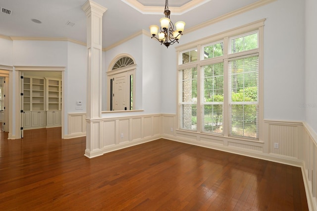 4535 SW 105th Dr, Gainesville, FL 32608 - unfurnished dining area featuring a chandelier, plenty of natural light, a wainscoted wall, dark wood-style flooring, and ornamental molding