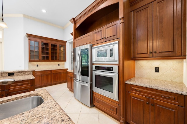 4535 SW 105th Dr, Gainesville, FL 32608 - kitchen featuring appliances with stainless steel finishes, backsplash, ornamental molding, pendant lighting, and glass insert cabinets