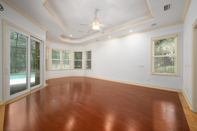 4535 SW 105th Dr, Gainesville, FL 32608 - unfurnished room featuring a tray ceiling, crown molding, healthy amount of natural light, and wood finished floors