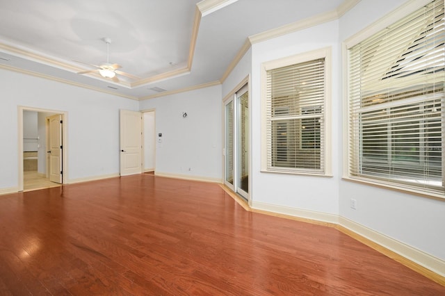 4535 SW 105th Dr, Gainesville, FL 32608 - spare room with ornamental molding, a tray ceiling, wood finished floors, a ceiling fan, and baseboards