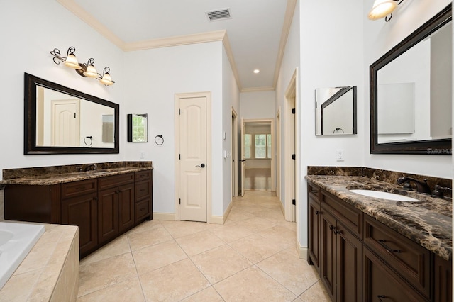 4535 SW 105th Dr, Gainesville, FL 32608 - bathroom featuring crown molding, two vanities, tile patterned flooring, baseboards, and tiled bath