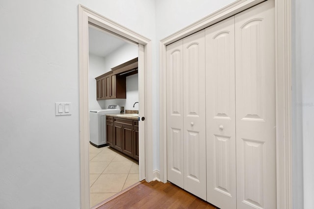 4535 SW 105th Dr, Gainesville, FL 32608 - hallway featuring washer / clothes dryer, a sink, and light wood-style flooring