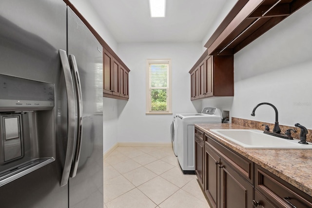 4535 SW 105th Dr, Gainesville, FL 32608 - laundry room with a sink, baseboards, light tile patterned floors, and washer and dryer