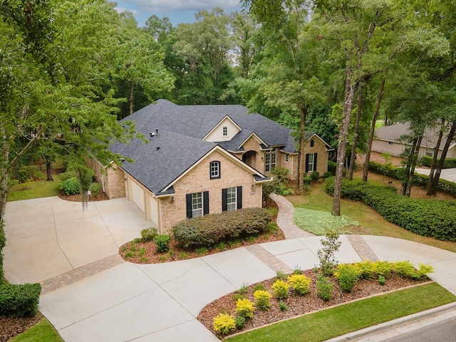 4535 SW 105th Dr, Gainesville, FL 32608 - traditional home featuring concrete driveway, brick siding, a garage, and a shingled roof