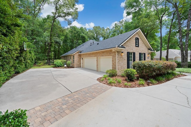 4535 SW 105th Dr, Gainesville, FL 32608 - view of property exterior featuring brick siding, driveway, a garage, and a shingled roof