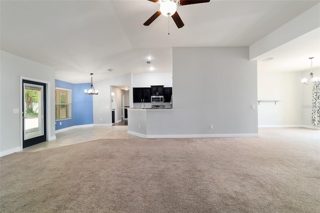 unfurnished living room featuring baseboards, vaulted ceiling, ceiling fan with notable chandelier, and light carpet