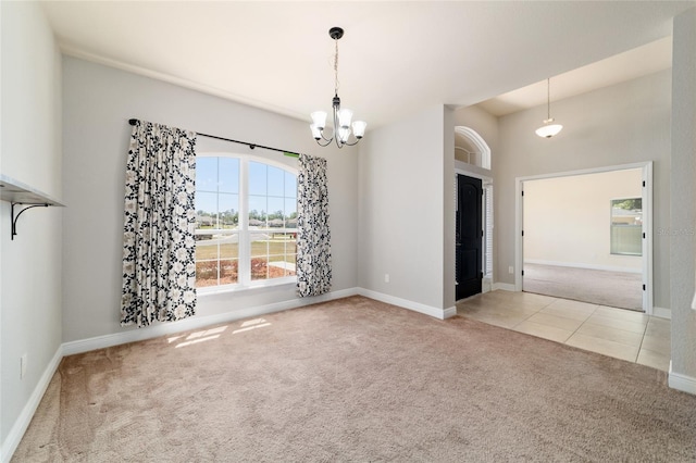 tiled spare room featuring baseboards, carpet floors, and a notable chandelier